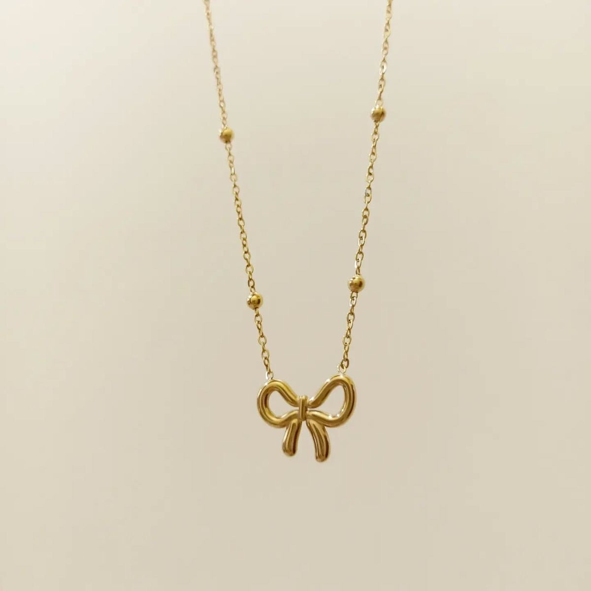 Golden Bow Pendant Necklace – Playful Elegance with a Feminine Twist
