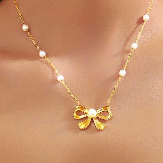 Gold Bow Necklace with Pearl Accents